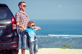 Photo of father and son standing outside of car - Auto Insurance in South Shore MA, Plymouth MA and Cambridge MA